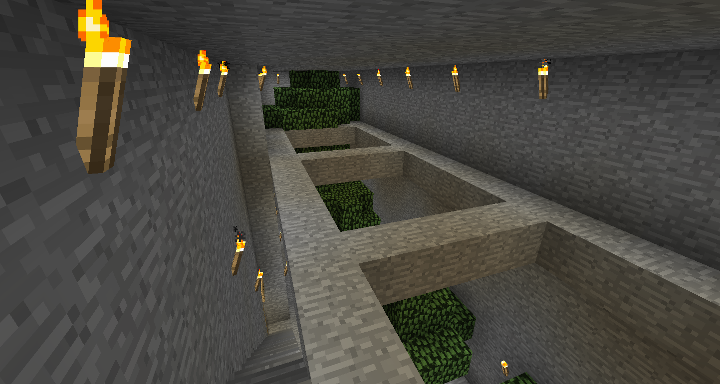 A large underground base with multiple rooms and a staircase, featuring green blocks and lit torches.