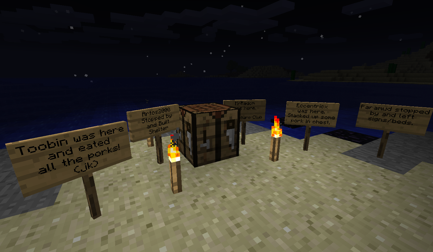 A collection of signs on the ground with text, some of which are on fire.