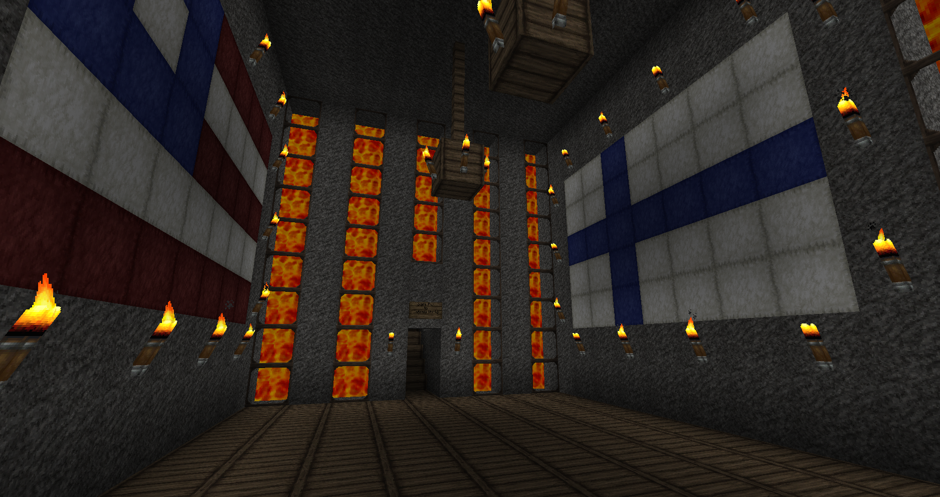 A large room with a high ceiling, featuring a prominent display of flags on the walls and a series of lit torches along the floor.