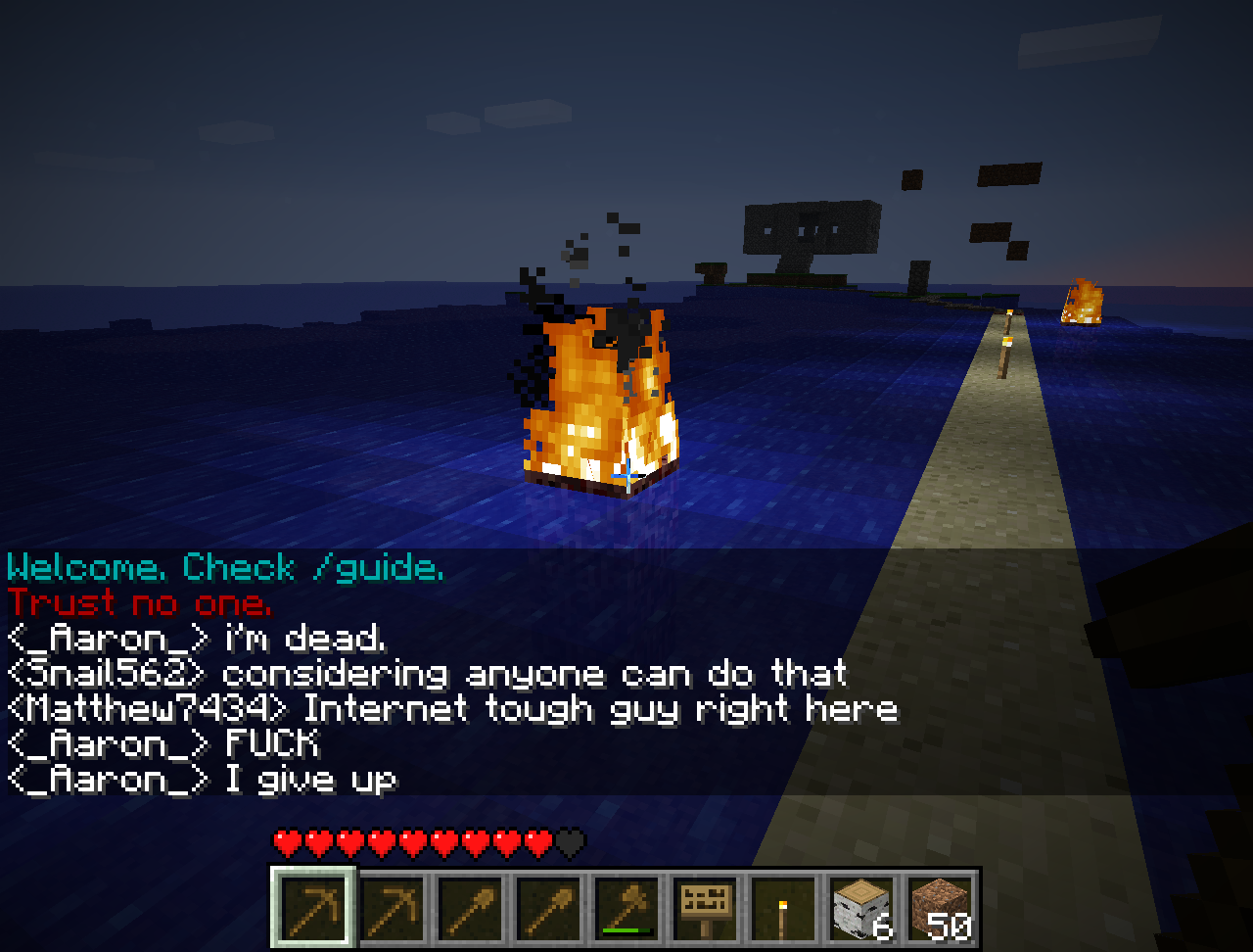 A player is standing on a road in the middle of the ocean, surrounded by lava and fire. The chat window shows messages from other players.