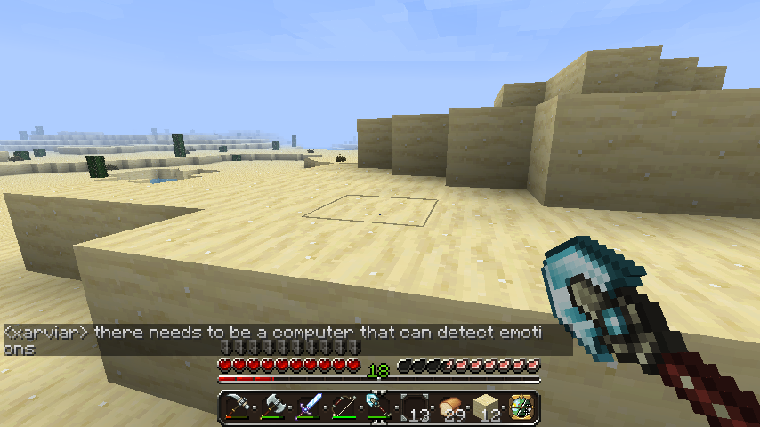 A desert biome with a large sand structure, and a player's inventory visible.