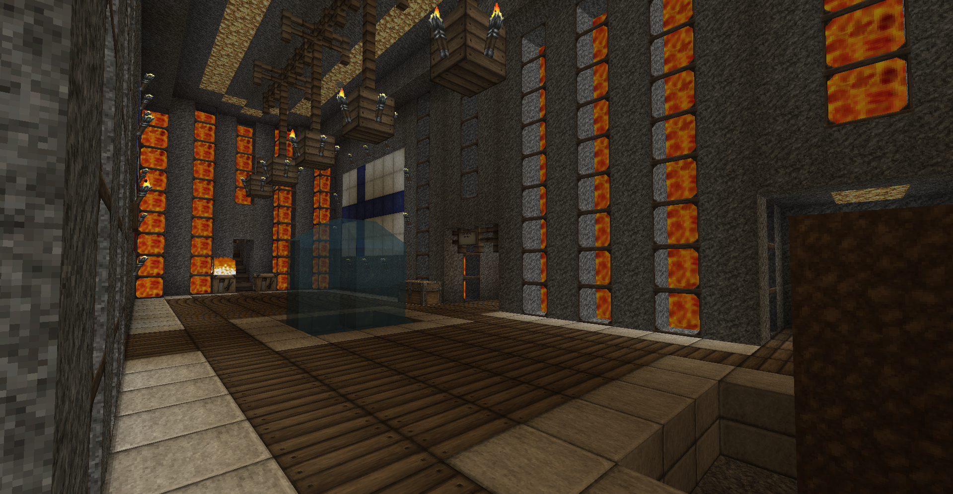 A large, dimly lit room with a high ceiling and rows of windows along the walls. The room is filled with various objects and structures, including what appears to be a large, blue, glowing portal or doorway at the far end.