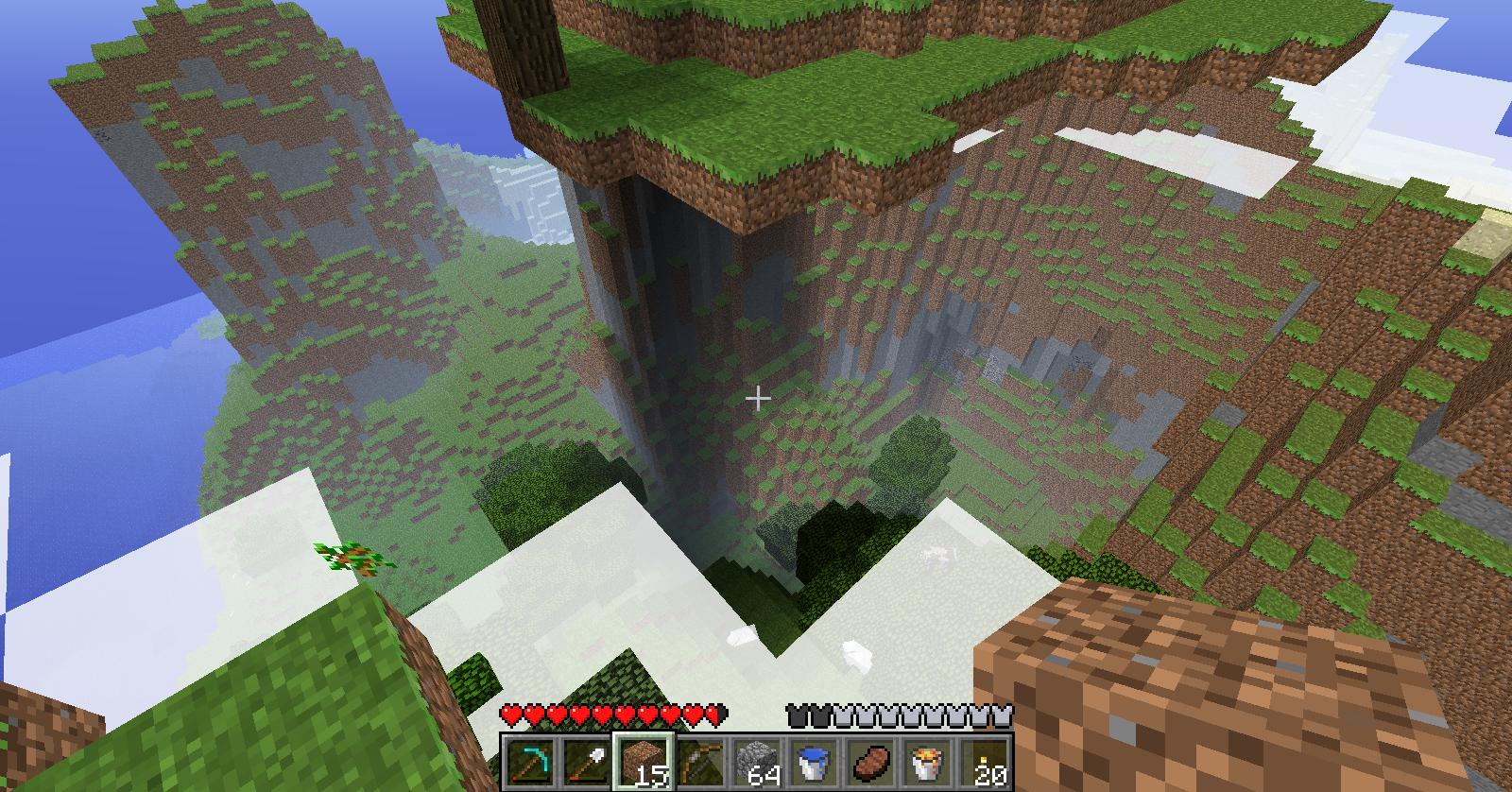 A large, natural-looking structure with a waterfall and trees on top, surrounded by a cliffside with a few blocks of dirt and grass.