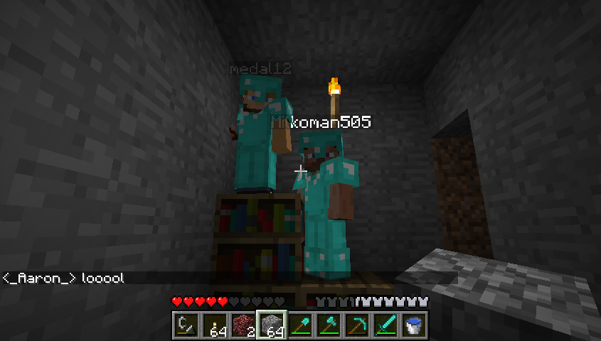 Three players standing on a bookshelf in a dimly lit room.