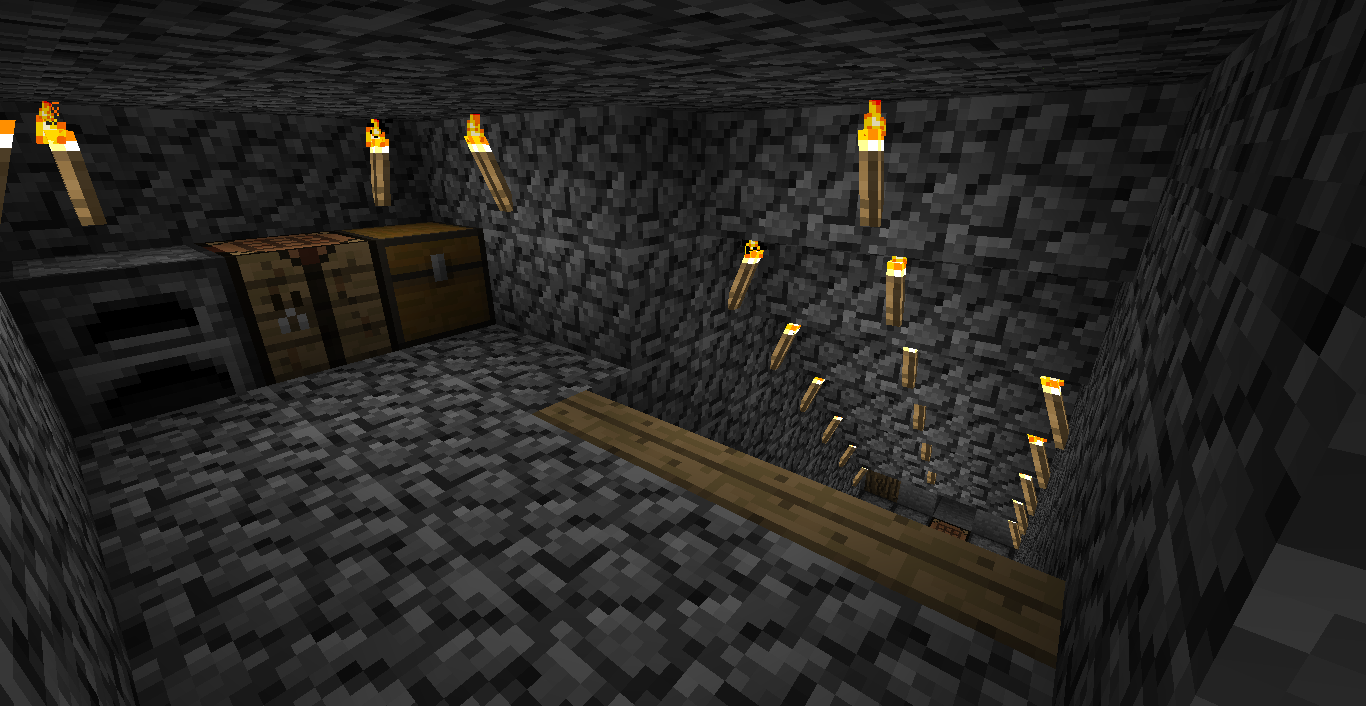 A dimly lit room with a stone floor and walls, featuring a series of lit torches on the ceiling and a collection of chests and boxes in the corner.
