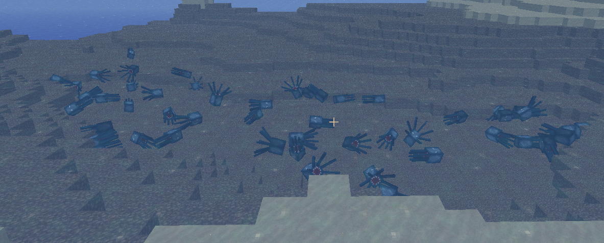 A large number of blue and black items scattered on the ground in a desert biome.