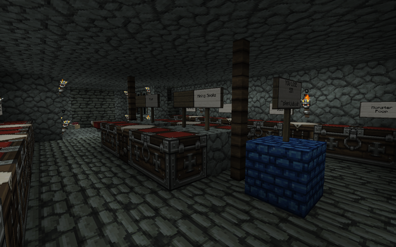 A large underground base with many chests and signs, and a blue block structure in the center.