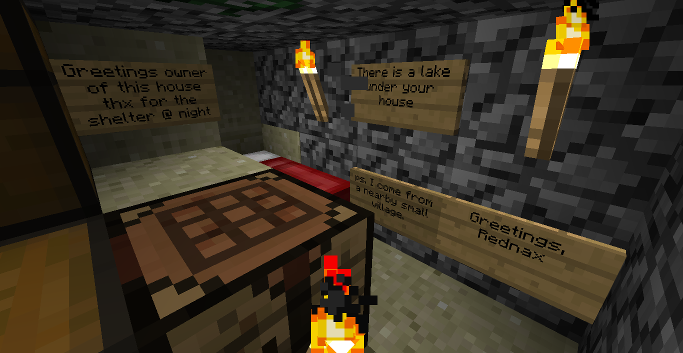A small underground base with signs and a chest, lit by glowstones.