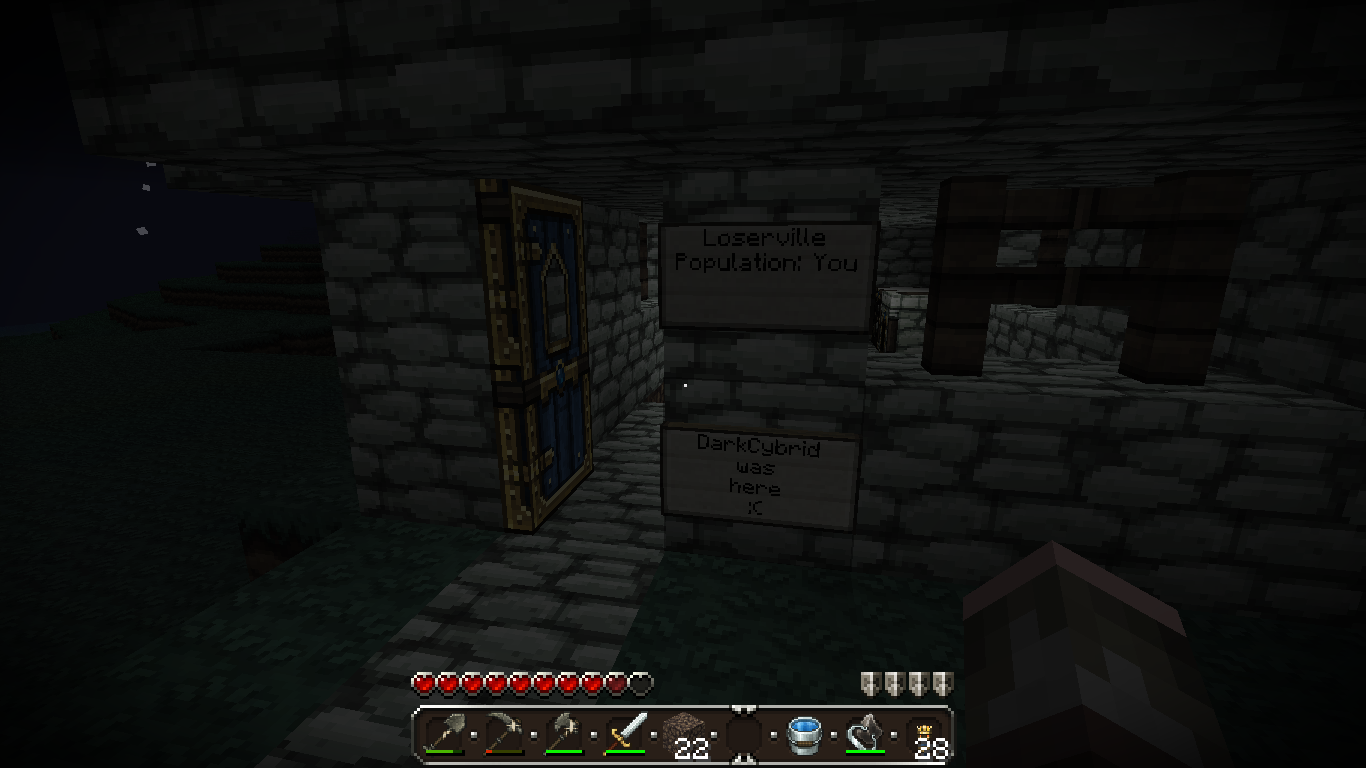 A dark room with a door and signs on the wall.