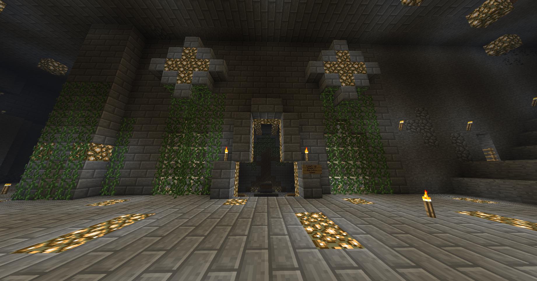A large stone structure with vines and torches, featuring a central entrance and stairs leading up to it.