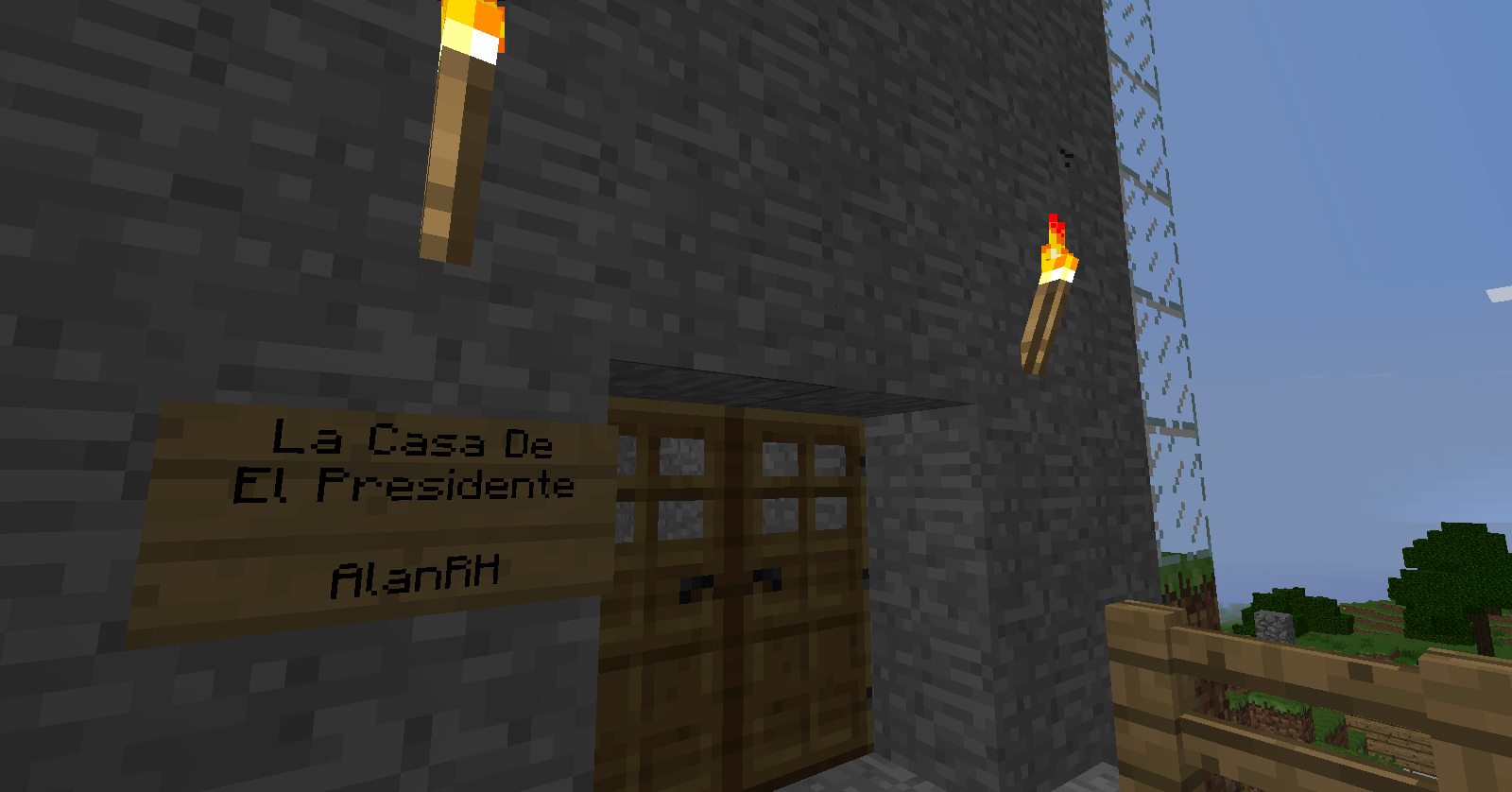 A building with a sign that reads 'La Casa De El Presidente' and 'AlanfH' in front of it.