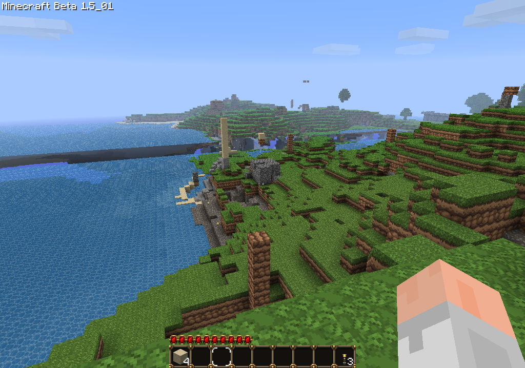 A screenshot of a Minecraft world with a body of water and green grassy terrain.