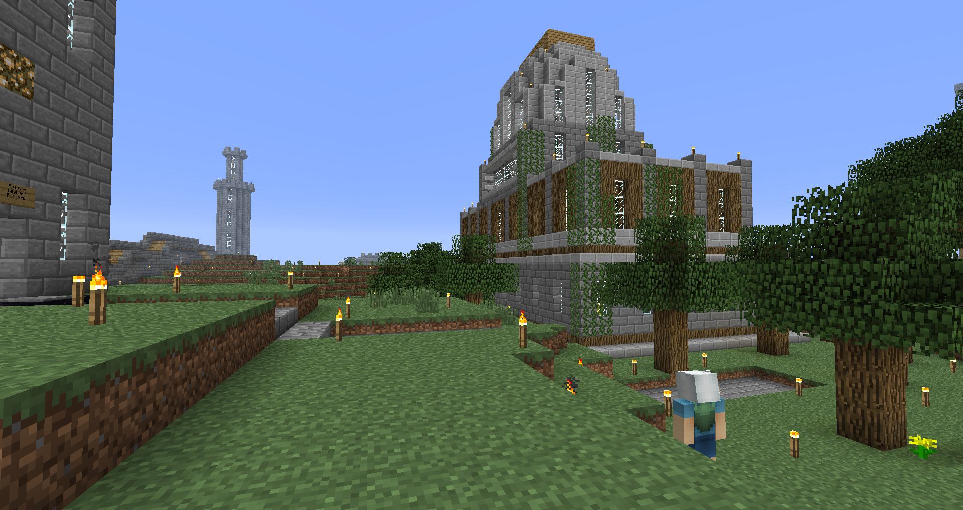 A large building with a garden in front of it, featuring trees and a path.