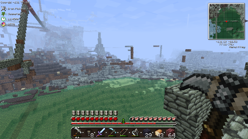A player is standing on a hill, looking at a large base in the distance.