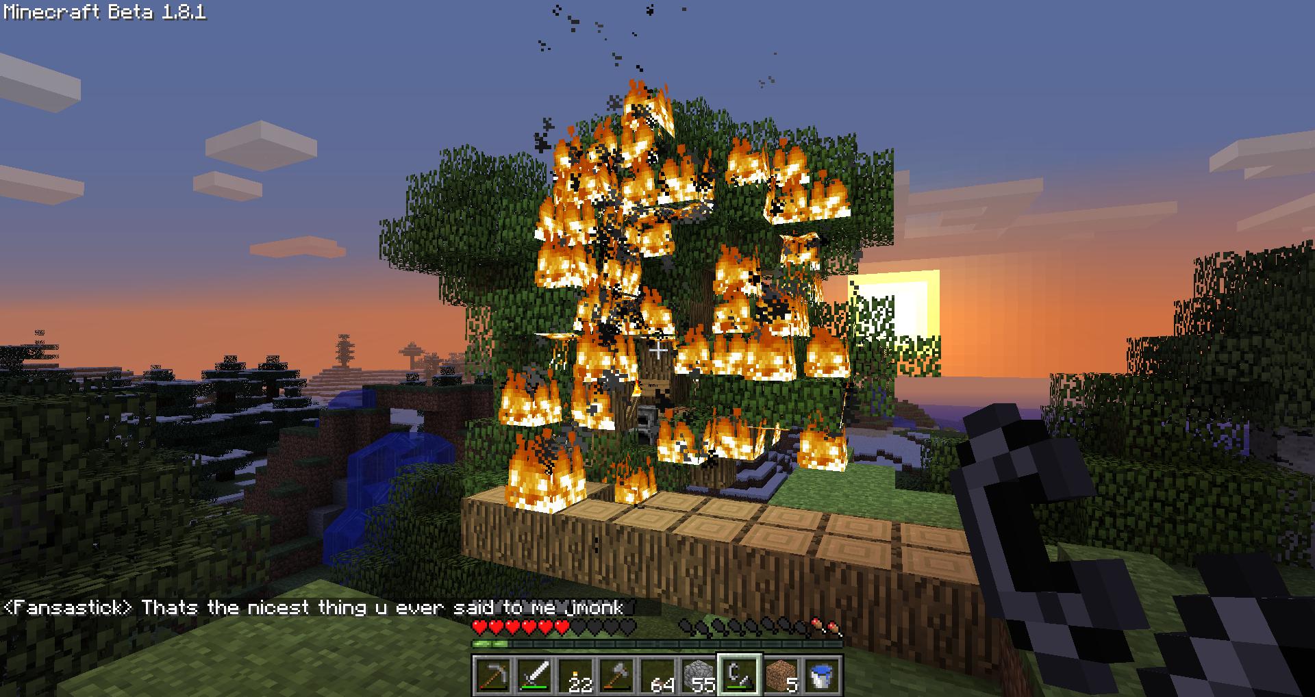 A tree on fire with a player in the background, and a chat message from Fansastick.