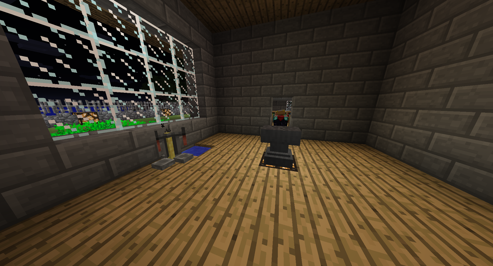 A room with a wooden floor and stone walls, featuring a large window on the left side.