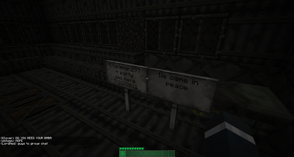 A dark room with a sign that says 'He came in peace' and a chat message asking if someone needs help.