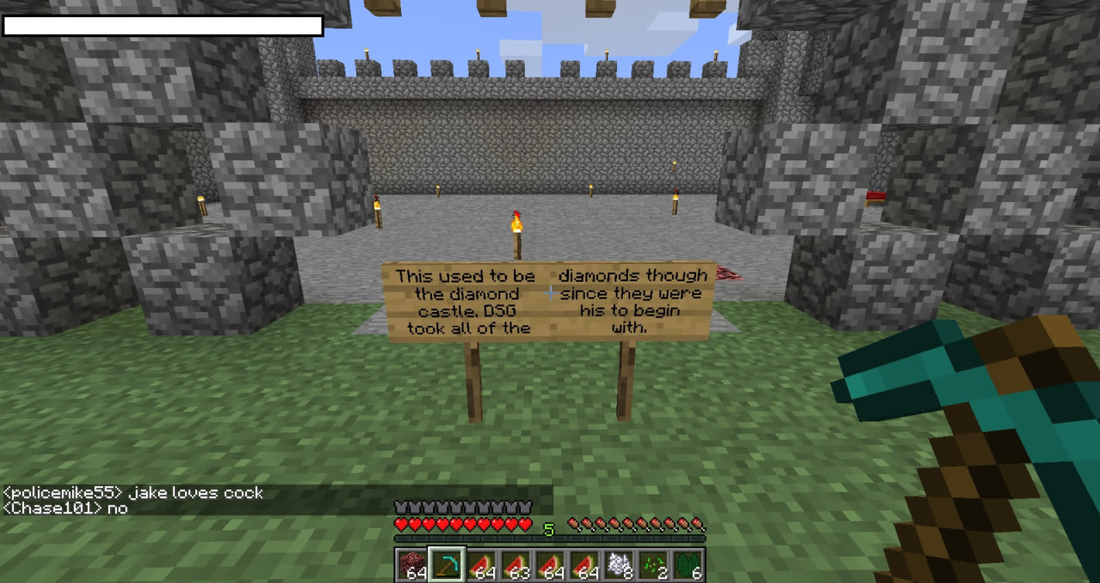 A sign in a castle with a message about diamonds, and a player's chat message.
