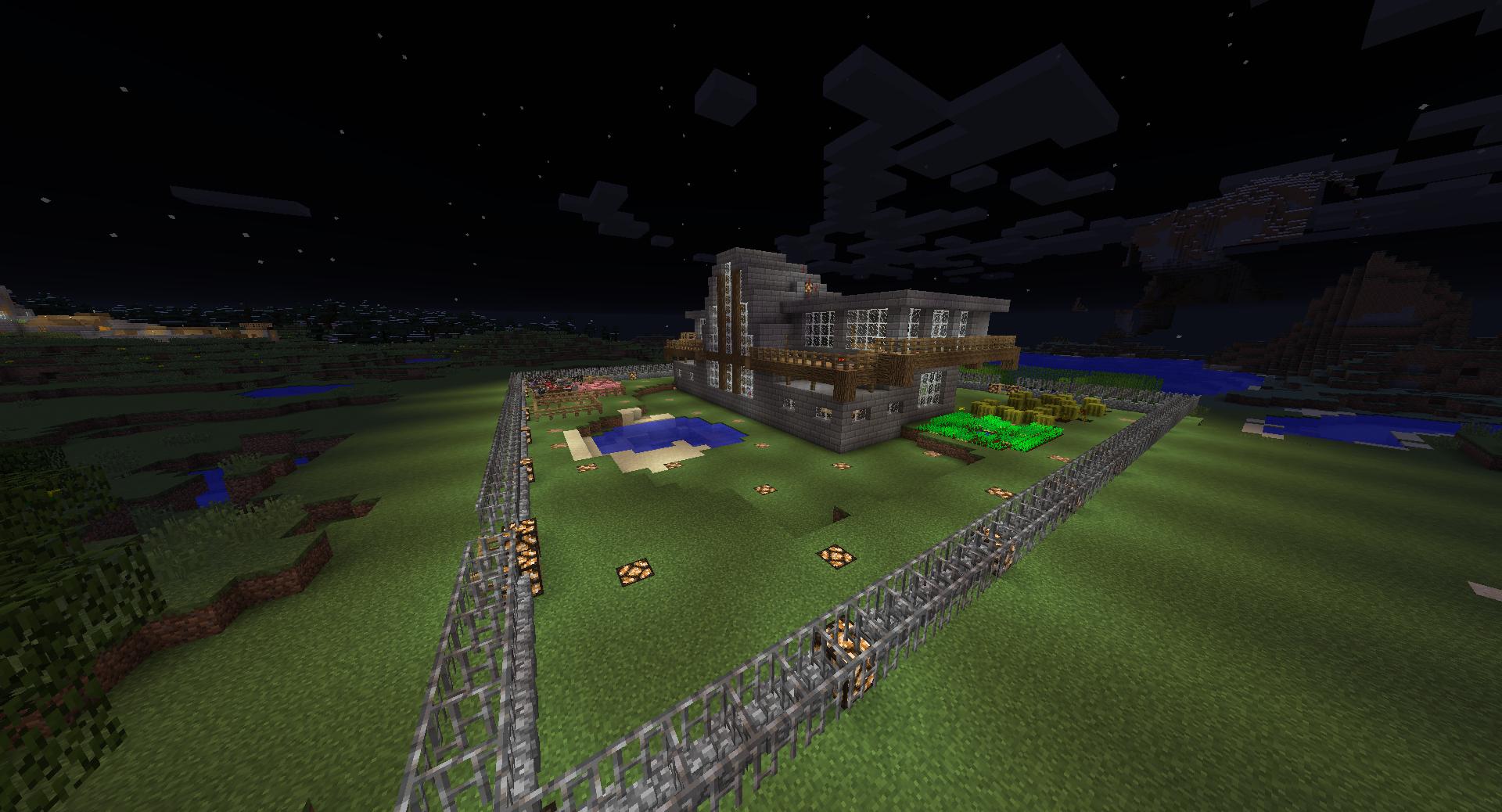 A large base with a fence and a building in the middle of a grassy field.