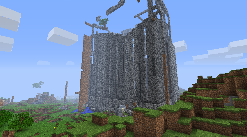 A large, unfinished build in the middle of a grassy field.