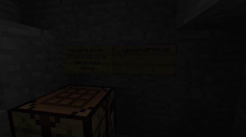 A dark room with a chest and a sign on the wall.