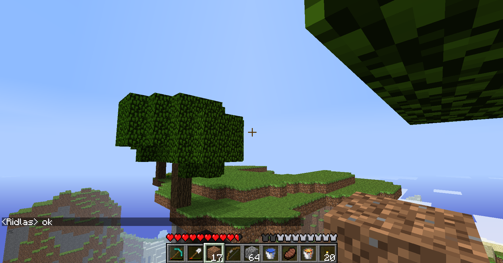 A small island with trees and grass, surrounded by water.