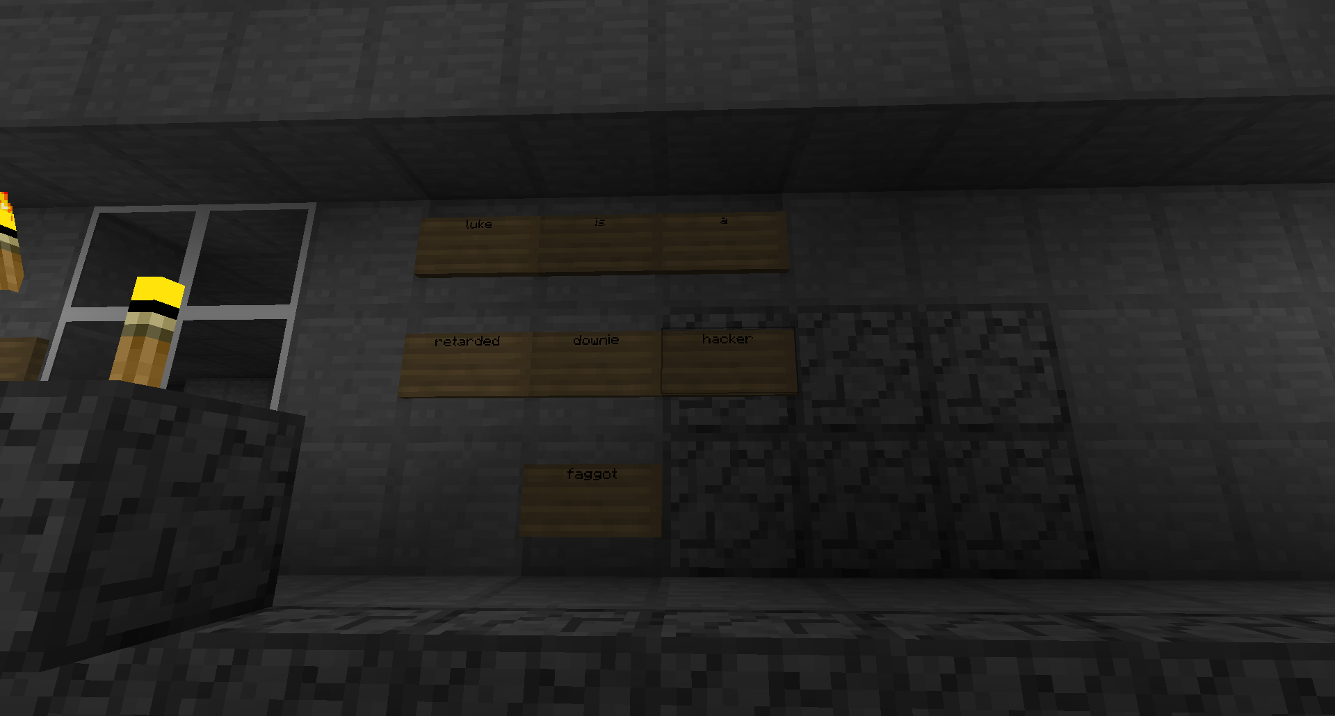 A dark room with a window and a wall of signs.