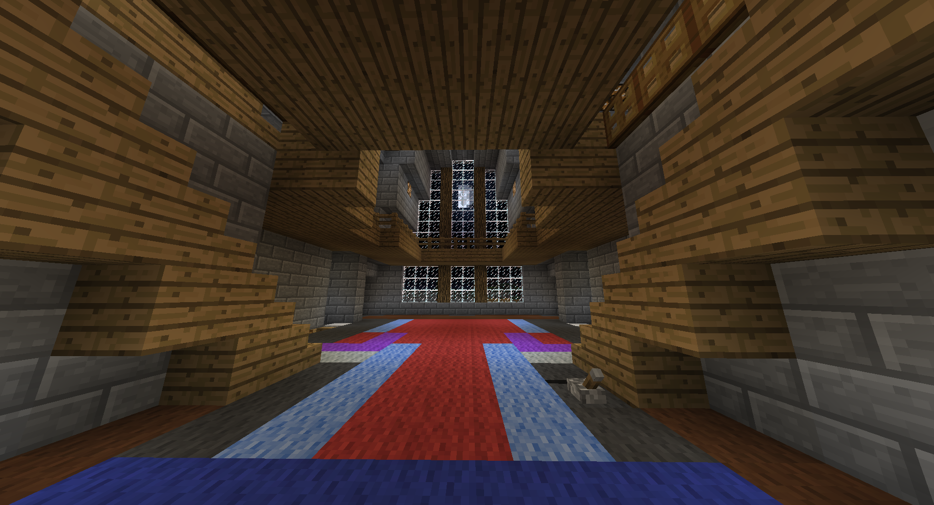 A large room with a British flag on the floor, surrounded by wooden walls and a high ceiling.