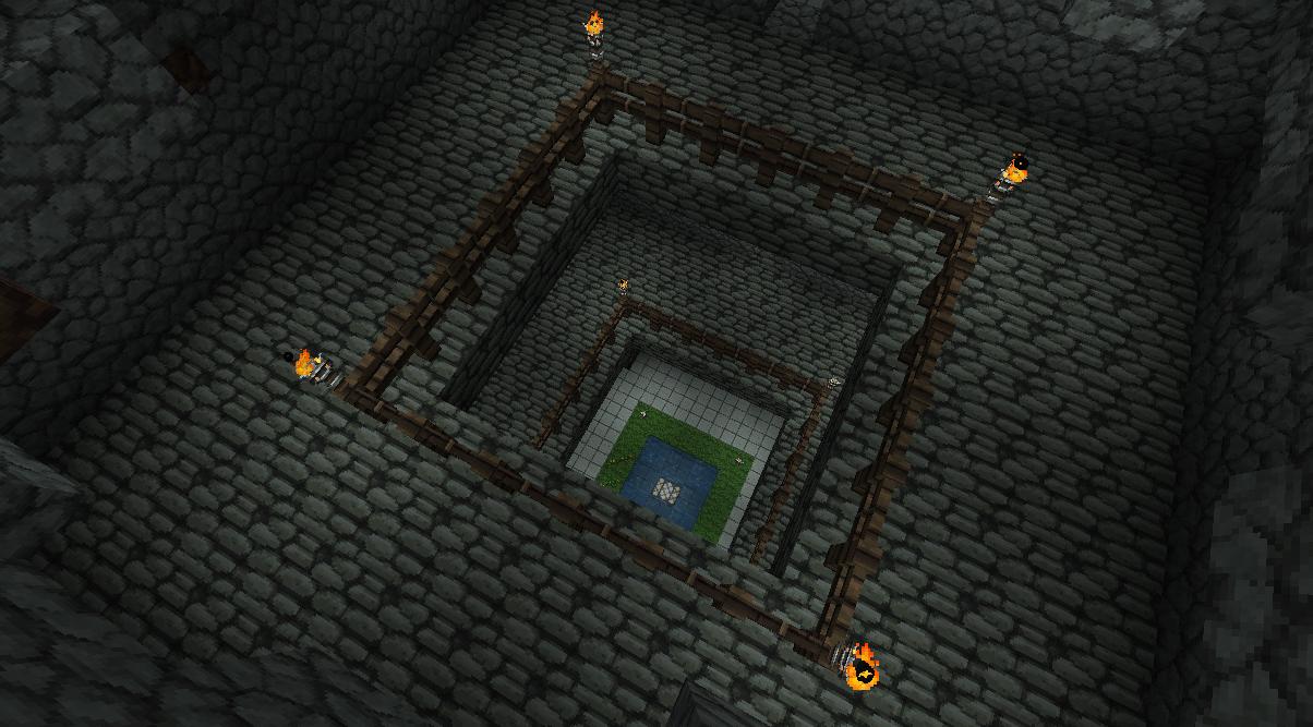 A large underground base with a square design and a central room, surrounded by a stone wall and lit by torches.