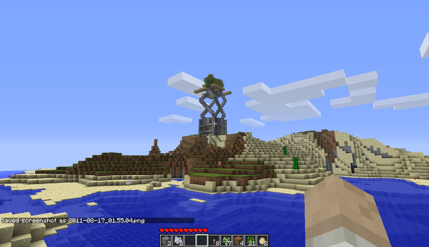A large island with a tree and a building on it, in the middle of the ocean.