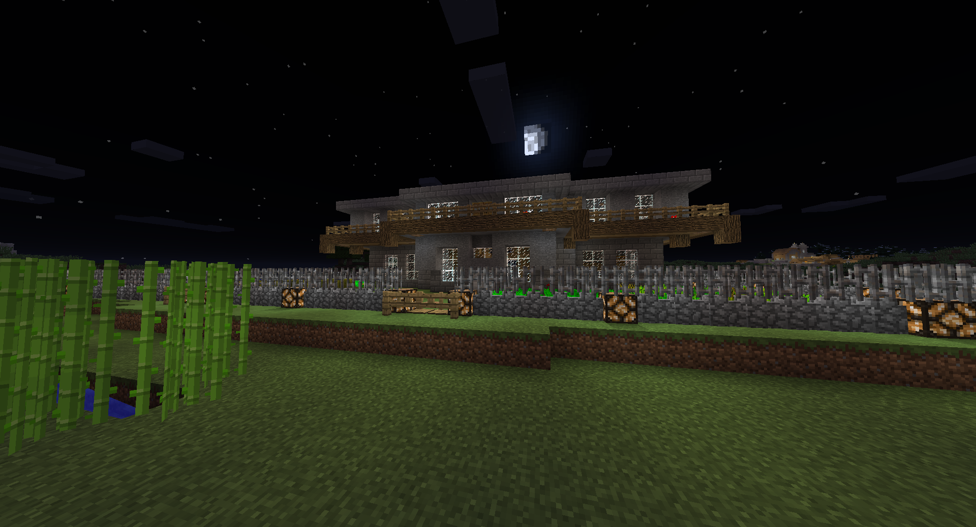 A large base with a garden and a fence, at night.