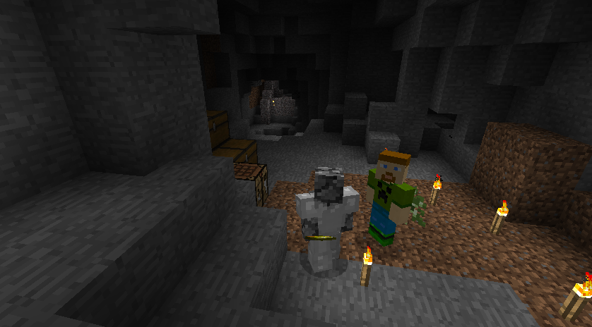 A group of players standing in a cave with lit torches and a stone structure.