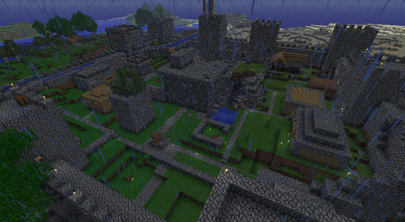 A large castle with a moat and towers, surrounded by a wall with a gatehouse.