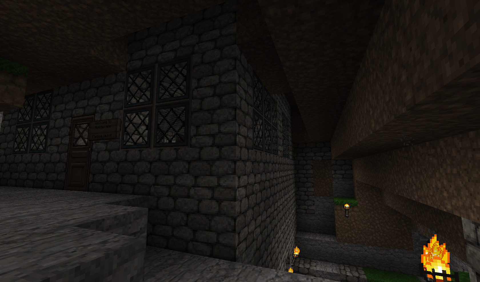 A dark and mysterious base with a fire pit, surrounded by stone walls and windows.