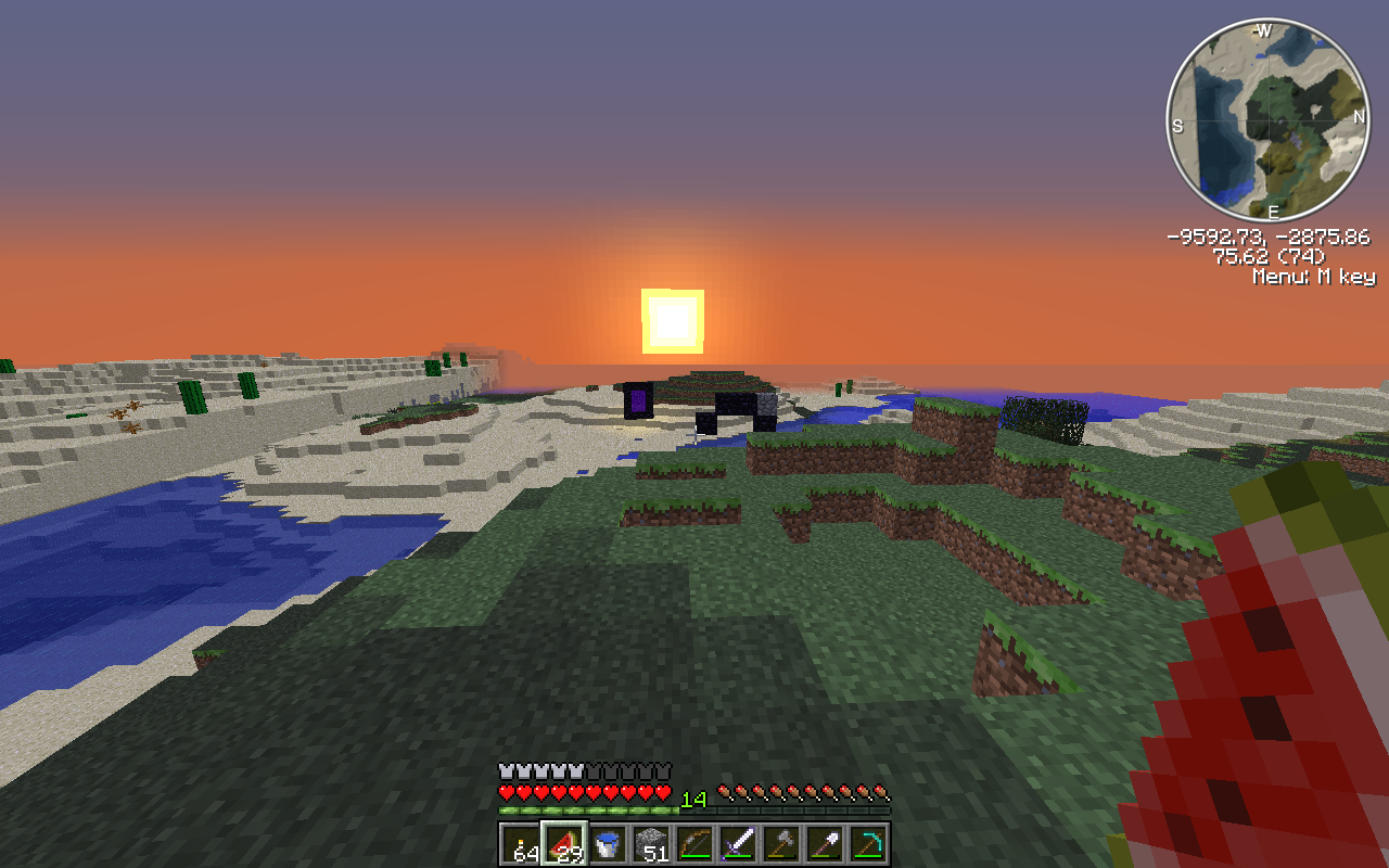 A sunset over a snowy landscape with a river and a small island in the distance.