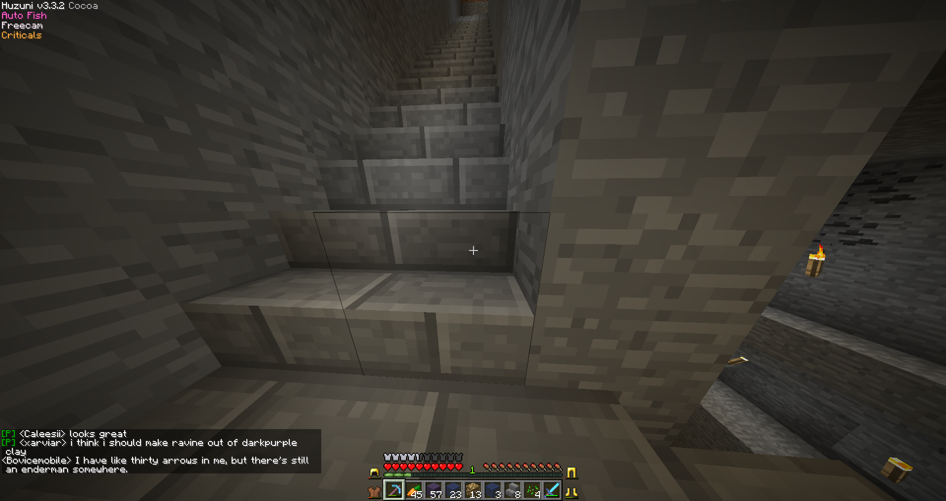 A dark underground room with a staircase and a few blocks of stone, with a player's inventory visible at the bottom.