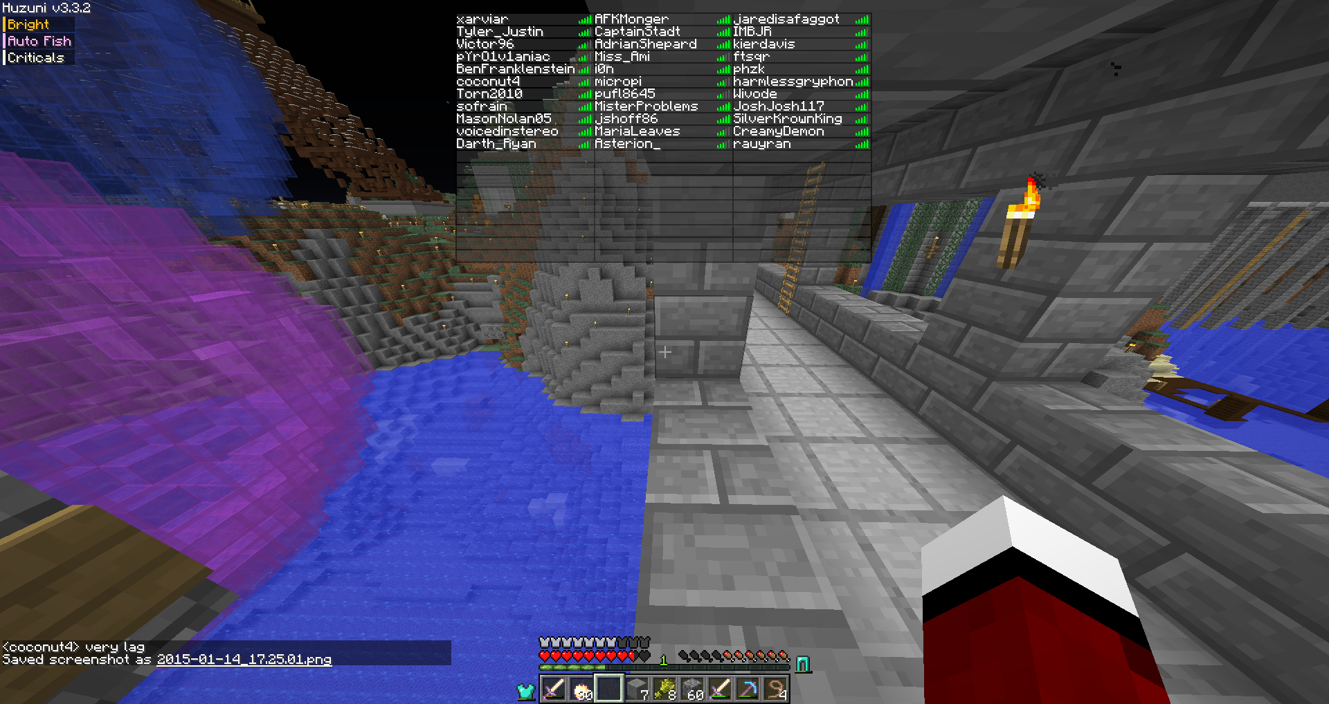 A player is standing in a large underground base with a blue and purple lava pool, surrounded by stone blocks and torches.