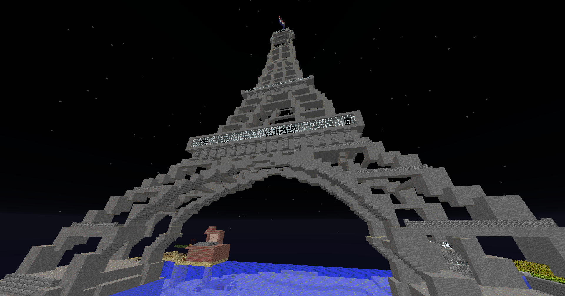 A build of the Eiffel Tower, with a small pool of water at its base.