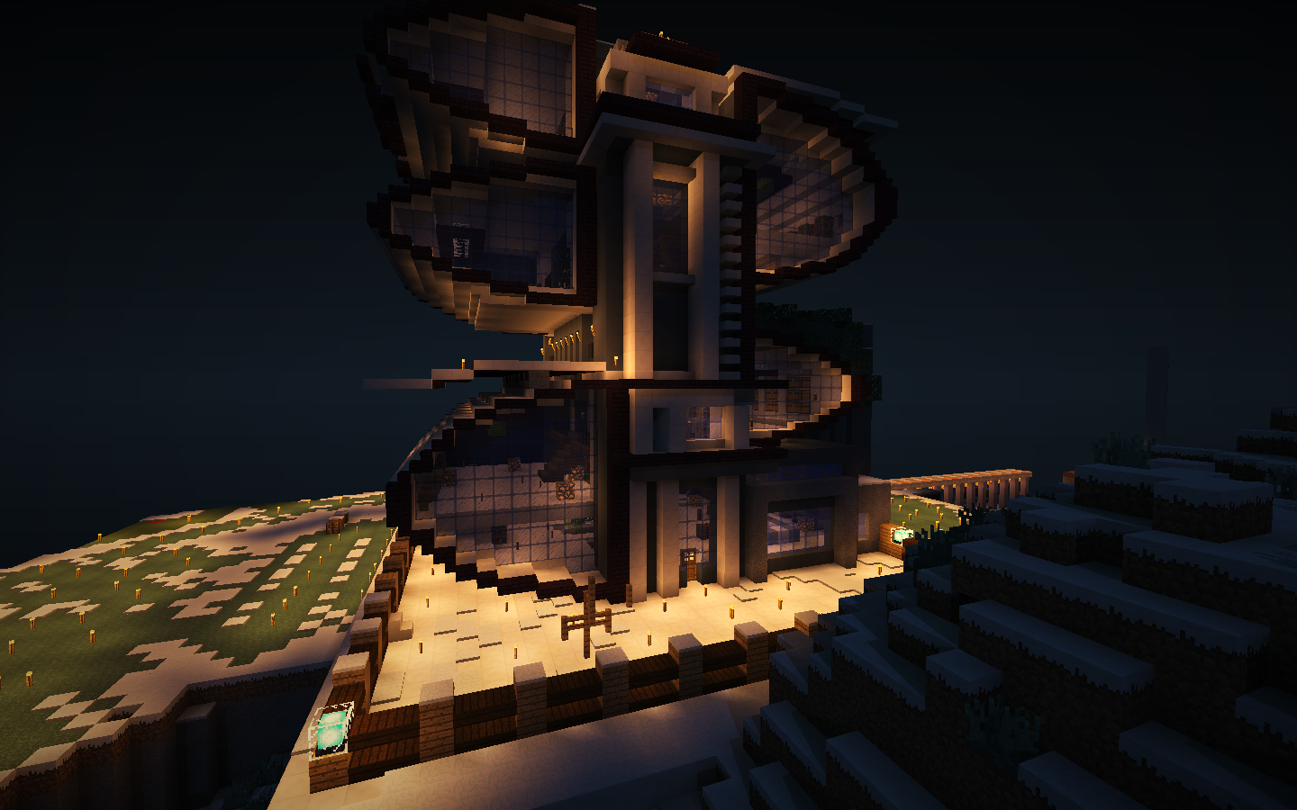 A large, futuristic-looking building with many windows and a unique design, situated on a hill in a snowy landscape.